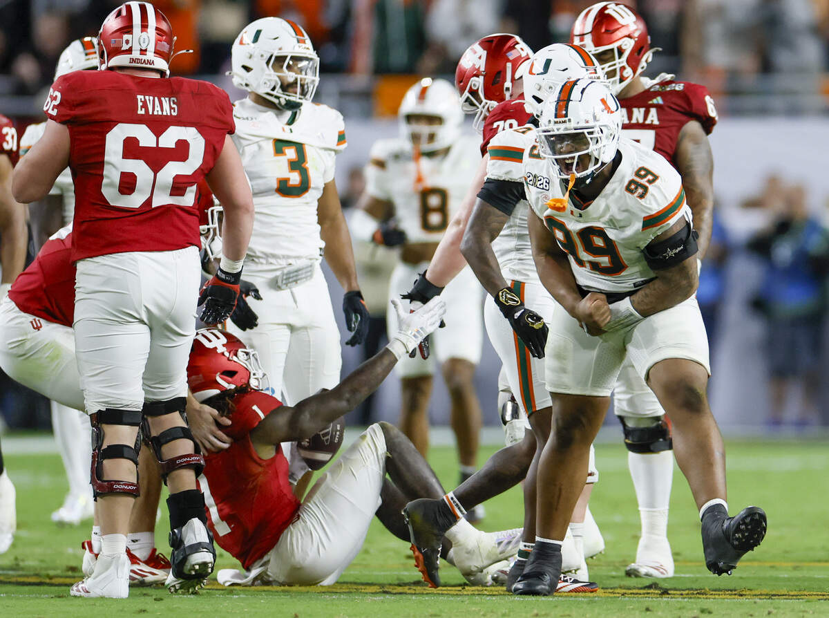 Miami Hurricanes defensive lineman Ahmad Moten Sr. (99) reacts after tackling Indiana Hoosiers running back Roman Hemby (1) in the first half of the College Football Playoff National Championship Game at Hard Rock Stadium in Miami Gardens, Florida, on Monday, January 19, 2026.